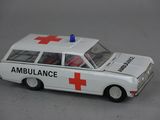 a white toy ambulance with a red cross on the roof