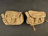 pair of old leather baseball mitts on a gray surface