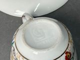 a small cup and saucer sitting on a table