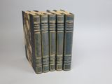 three books are stacked on top of each other on a white surface