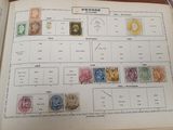 an open book with stamps on it sitting on a table