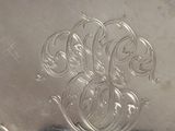a silver plate that has a design on it