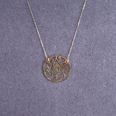 un collier en argent avec un motif circulaire sur une chaîne