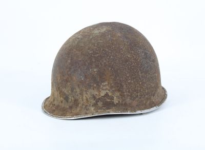 an old helmet on a white surface with a white background
