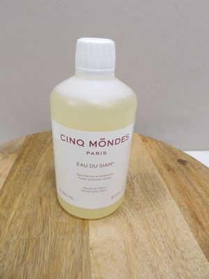 une bouteille de liquide posée sur une table en bois