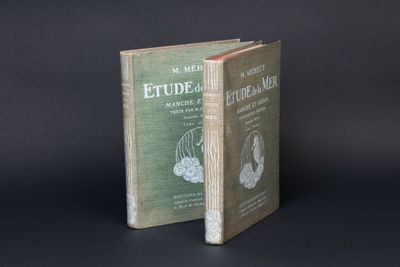 an old book sitting on top of a table next to another book
