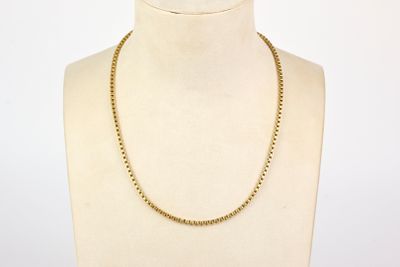 necklace on a mannequin display with a white background