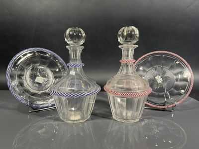 three glass decanters are sitting on a table with a black background