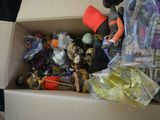 a cardboard box filled with toys and other items