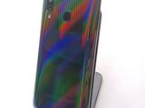 the back of a cell phone with a multicolored design on it