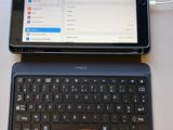 a laptop computer sitting on top of a table next to a tablet computer