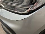 a close up of a car ' s headlight and front bumper