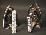 two pieces of metal that are on a table