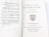 an open book with a picture of a coat of arms on it