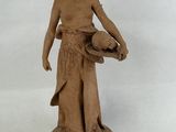 a statue of a woman holding a bowl of food