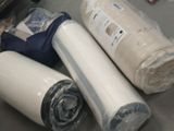 three rolls of toilet paper on the floor next to a roll of toilet paper