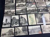 a lot of old black and white pictures on the table