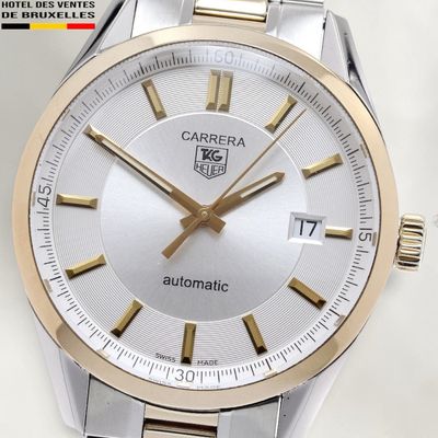 a close up of a watch with a white face
