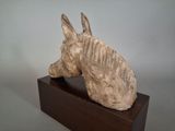 a sculpture of a horse head on top of a wooden block