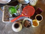 a red racket sitting on top of a table next to cups of coffee