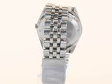 a close up of a watch on a white surface