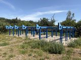 a blue structure in the middle of a field