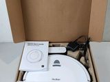 packaging of a box with a white electronic device inside of it