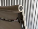 a white chair that is sitting in front of a wall