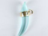 a small blue piece of glass with a gold clasp on it