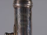 a close up view of a silver plated instrument on a table