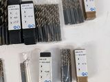 many different types of drill bits on the table