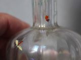 a person holding a glass vase with flowers in it