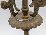 a metal candle holder with a bird on it