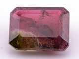 a close up of a pink tourmaline stone on a white surface