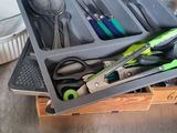 a tray with utensils, spoons, and other kitchen utensils in it