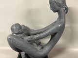statue of a woman holding a baby in her lap