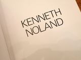 the book is open on a wooden table with a black and white picture