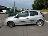 a small silver car parked in a parking lot