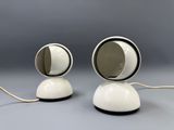 pair of white and black table lamps on a gray surface