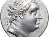 a close up of a silver coin with a man ' s head on it