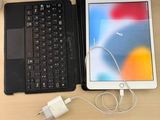 a tablet and a laptop sitting on a desk next to each other