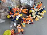 many figurines of dragon ball characters on the table