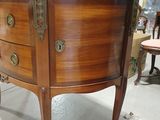 a marble top cabinet in the middle of a room