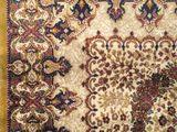 a close up of a rug on a wooden floor