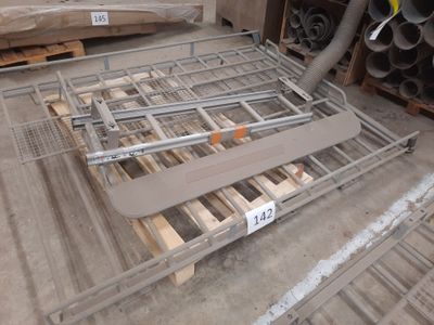 a metal bed frame on a pallet in a warehouse