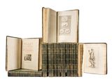 several old books are stacked on top of each other on a white surface