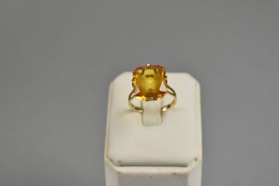 a close up of a ring with a citrine stone in it
