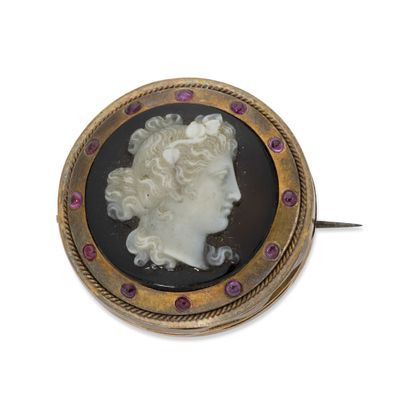 an image of a woman ' s head in a gold and black broochle