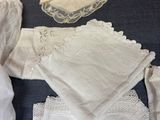 a lot of white cloths and napkins on a table