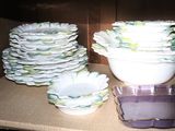 a lot of dishes and bowls on the counter